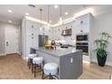 Well-equipped kitchen with white cabinets, granite countertops, and a functional island at 1910 W Desert Hollow Dr, Phoenix, AZ 85085