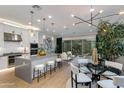 Open-concept living space featuring a modern kitchen, dining area, and bright living room at 1910 W Desert Hollow Dr, Phoenix, AZ 85085