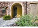 Inviting front entrance with a stone archway, landscaped garden, and warm, welcoming ambiance at 20750 N 87Th St # 2115, Scottsdale, AZ 85255