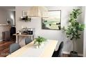 Dining area features a modern light fixture and table, complemented by a plant and minimalist decor at 2150 E Bell Rd # 1068, Phoenix, AZ 85022