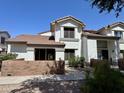 Two story home featuring a stucco exterior, beautiful brick fencing, and modern windows at 2201 N Comanche Dr # 1093, Chandler, AZ 85224
