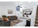 Bright living room featuring high ceilings, ceiling fan, and an open floor plan connecting to the kitchen at 2201 N Comanche Dr # 1093, Chandler, AZ 85224
