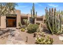 Charming desert home with beautiful xeriscaping, stone walkway, and mature cacti at 23760 N 80Th Way, Scottsdale, AZ 85255