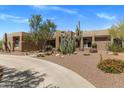 Beautiful desert home with gravel landscaping, cacti, and a circular driveway at 23760 N 80Th Way, Scottsdale, AZ 85255