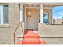 Close-up of the front porch with red steps, white pillars, and address plaque at 2546 N 9Th St, Phoenix, AZ 85006