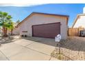 Well-kept single-story home exhibiting xeriscaping, and a neutral color palette under a clear blue sky at 2635 W Hearn Rd, Phoenix, AZ 85023
