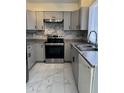 Well-lit kitchen features grey cabinets, stainless steel appliances, and marble countertops at 2635 W Hearn Rd, Phoenix, AZ 85023