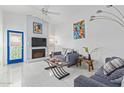 Bright living room featuring vaulted ceilings, cozy fireplace, modern decor, and ample natural light at 2635 W Hearn Rd, Phoenix, AZ 85023