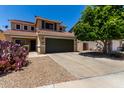 Inviting two-story home featuring a well-maintained front yard with a spacious driveway at 27420 N 63Rd Dr, Phoenix, AZ 85083