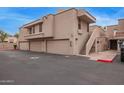 Condominium exterior featuring a private garage, an exterior staircase, and a desert-toned facade at 2834 S Extension Rd # 2005, Mesa, AZ 85210