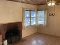 Living room with a brick fireplace and windows offering a cozy space ready to be personalized at 3115 N 26Th St, Phoenix, AZ 85016