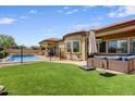 Spacious backyard with lush artificial turf, pool and patio is great for entertaining at 32819 N 23Rd Ave, Phoenix, AZ 85085