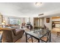 Spacious living room and dining area featuring comfortable seating, natural light, and a seamless flow into the kitchen at 3655 N 5Th Ave # 202, Phoenix, AZ 85013