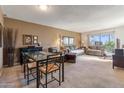 A roomy living room and dining space with large windows, comfortable seating, and neutral walls offers easy living at 3655 N 5Th Ave # 202, Phoenix, AZ 85013