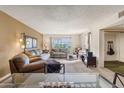 A well-lit living room with large sliding doors to a patio, comfortable couches, and neutral colors offers relaxed living at 3655 N 5Th Ave # 202, Phoenix, AZ 85013