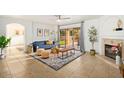 Bright living room featuring a sliding glass door, fireplace, and open floor plan at 4341 E Abraham Ln, Phoenix, AZ 85050