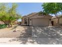 Attractive single-Gathering home featuring xeriscaping, an attached two-car garage, and neutral color palette at 43803 W Wade Dr, Maricopa, AZ 85138