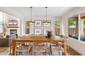 Bright dining area with natural wood table, seating for six, and view to the backyard at 4430 E Creosote Dr, Cave Creek, AZ 85331