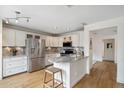 Bright kitchen boasts stainless steel appliances, marble countertops, and light wood flooring at 4430 E Creosote Dr, Cave Creek, AZ 85331