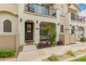 Inviting townhome facade with private porch, balcony, and desert landscaping at 4637 S Jetty --, Mesa, AZ 85212