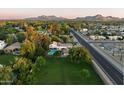 Expansive property featuring a sparkling private pool, lush greenery, and stunning mountain views at 5202 E Larkspur Dr, Scottsdale, AZ 85254