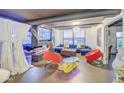 Open-concept living area with sleek fireplace feature and plush blue sofa, bathed in natural light at 535 W Thomas Rd # 513, Phoenix, AZ 85013