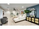 Comfortable living room showcases an elegant white sofa, decorative furniture, and a large window for natural light at 5441 E Wethersfield Rd, Scottsdale, AZ 85254