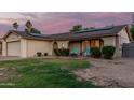 Charming single-Gathering home showcasing solar panels on the roof and a seating area in front at 5529 W Villa Maria Dr, Glendale, AZ 85308