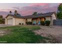Charming single-Gathering home showcasing solar panels on the roof and a seating area in front at 5529 W Villa Maria Dr, Glendale, AZ 85308