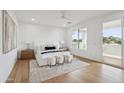 Bright and airy main bedroom featuring wood floors, a ceiling fan, and a private balcony with mountain views at 5537 E Earll Dr, Phoenix, AZ 85018