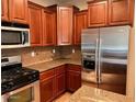 Close-up shot showcasing granite countertops, stainless steel appliances, and wooden cabinetry in kitchen at 5635 W Huntington Dr, Laveen, AZ 85339
