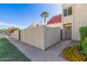 Townhome featuring desert landscaping, a palm tree, and a private courtyard entry at 6004 N 79Th St, Scottsdale, AZ 85250
