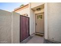 Close-up of the front door with decorative gate and inviting 'hello' mat at 6004 N 79Th St, Scottsdale, AZ 85250