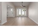 Bright living room featuring wood floors and glass doors leading to the outdoors at 6004 N 79Th St, Scottsdale, AZ 85250