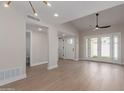 Living room with wood floors, modern fan, and glass doors leading to the outdoors at 6004 N 79Th St, Scottsdale, AZ 85250