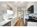 Modern kitchen featuring white cabinets, stainless steel appliances, and light countertops at 6349 N 78Th St # 105, Scottsdale, AZ 85250