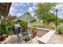 Outdoor patio featuring a dining set with umbrella and golf course views at 6349 N 78Th St # 105, Scottsdale, AZ 85250