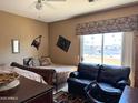 A bedroom with an outdoor view featuring a sofa and two beds at 6535 E Superstition Springs Blvd # 217, Mesa, AZ 85206