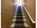 Carpeted staircase leading to the upper level with neutral walls and a white handrail at 6535 E Superstition Springs Blvd # 217, Mesa, AZ 85206