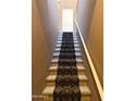 Carpeted stairway with white railing leading to the upper level of the home at 6535 E Superstition Springs Blvd # 217, Mesa, AZ 85206