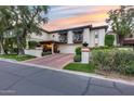 Charming two-story home featuring a terracotta roof, landscaped front yard, and private balconies with decorative accents at 6701 N Scottsdale Rd # 26, Scottsdale, AZ 85250