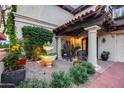 Charming front porch featuring decorative planters, a tiered fountain, and cozy seating, creating an inviting entrance at 6701 N Scottsdale Rd # 26, Scottsdale, AZ 85250