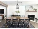 Elegant dining room with brick fireplace, a large table, and stylish decor, perfect for entertaining at 694 W Park Ave, Chandler, AZ 85225