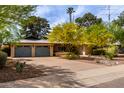 Beautiful home with well-maintained landscaping, complemented by a spacious driveway and attached two-car garage at 7202 N 16Th Dr, Phoenix, AZ 85021