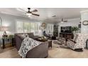 Bright living room featuring a large sectional sofa, wood floors, plantation shutters, and stylish decor at 7202 N 16Th Dr, Phoenix, AZ 85021