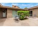 Private patio area featuring outdoor seating, neutral stucco walls and a glimpse of Arizona living at 7210 N 17Th Ave, Phoenix, AZ 85021