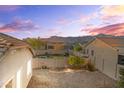 Private backyard featuring a gravel landscape, block wall fencing, and mountain views in the distance at 7577 S Towel Creek Dr, Gold Canyon, AZ 85118