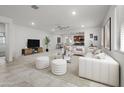 Bright, open-concept living room featuring neutral tones, tile flooring, and a seamless flow into the kitchen at 7577 S Towel Creek Dr, Gold Canyon, AZ 85118