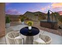 Cozy outdoor patio with modern furniture, potted plants, and a relaxing hot tub at 7577 S Towel Creek Dr, Gold Canyon, AZ 85118