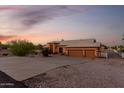 Charming home showcasing an expansive driveway leading to a spacious two-car garage at 8351 S Summit Dr, Casa Grande, AZ 85193